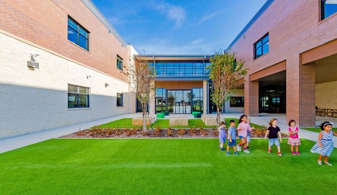 School playground covered with artificial turf for safe and clean play