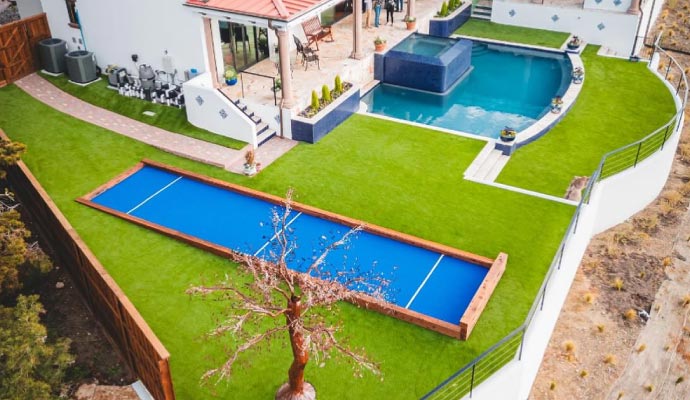 Installed artificial turf for bocce ball at residential house near the pool