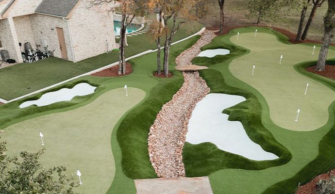 Artificial turf installed around trees for a natural and clean landscape