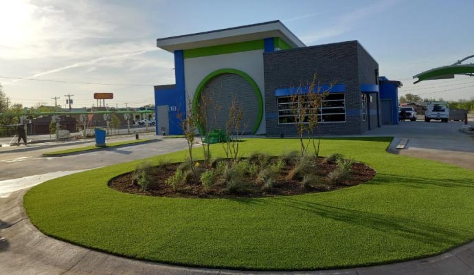 Close-up view of synthetic grass installed on a storefront