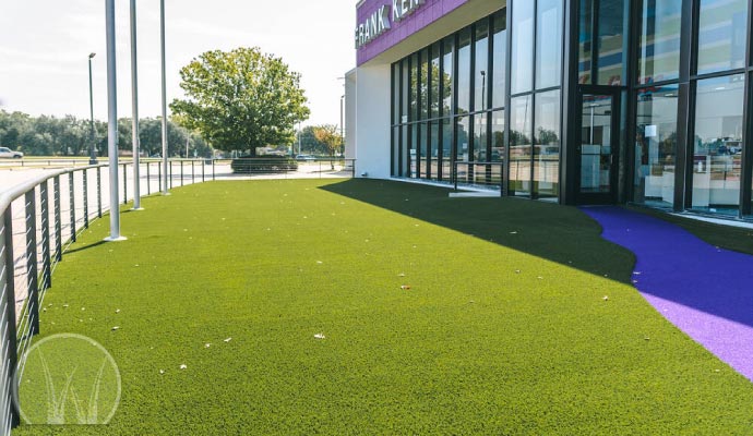 Storefront decorated with synthetic grass for an inviting appearance