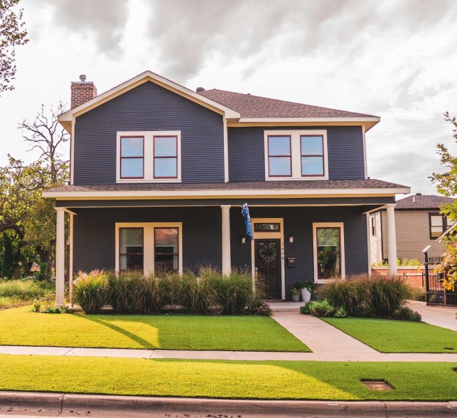Cozy house daytime shot. Surrounded by Artificial grass in front yards.