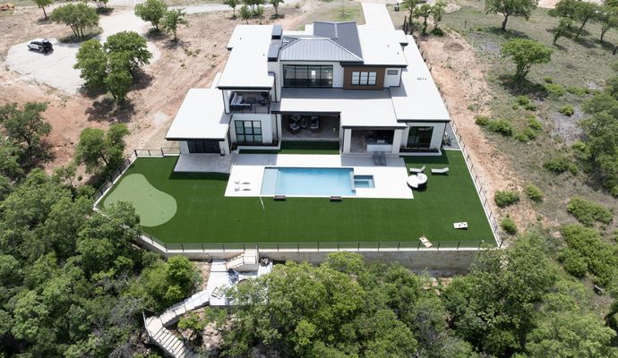 Installed synthetic grass around pool area at the back of the home