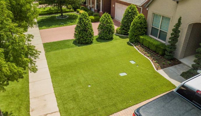 Residential front yard with synthetic grass Residential front yard with synthetic grass